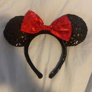 DISNEY: This black sequined Minnie Mouse ear headband with red sequined bow